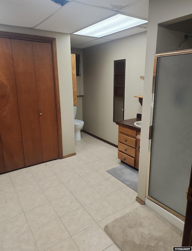 bathroom featuring a shower with door, vanity, and toilet