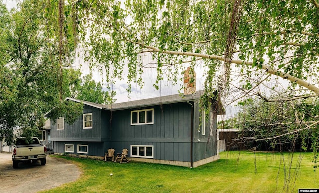 view of property exterior with a lawn