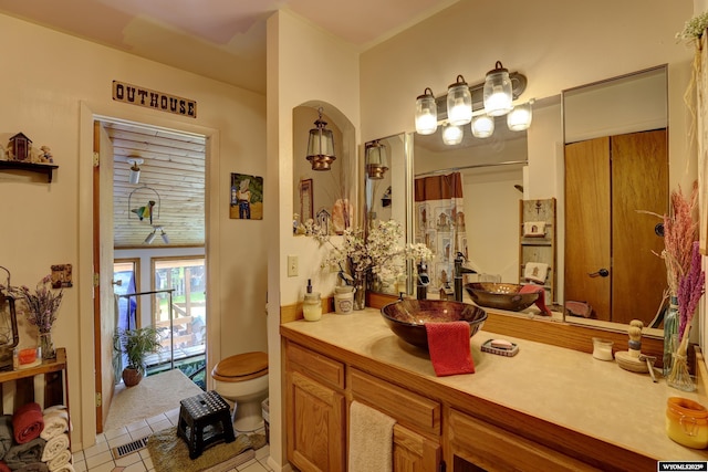 bathroom with tile patterned flooring, vanity, toilet, and a shower with curtain