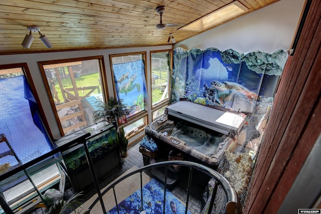 details with ceiling fan, wood ceiling, and a skylight