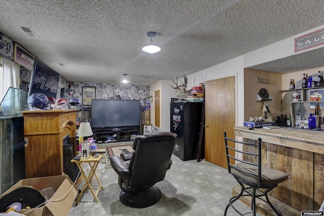 office featuring bar area and a textured ceiling