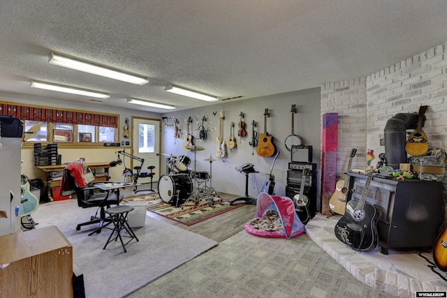 miscellaneous room with light carpet and a textured ceiling