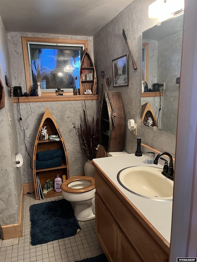 bathroom featuring tile patterned flooring, vanity, and toilet