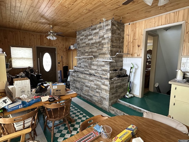 dining space with wood walls and wooden ceiling