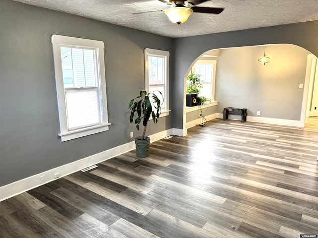 spare room featuring hardwood / wood-style floors, ceiling fan, and a textured ceiling