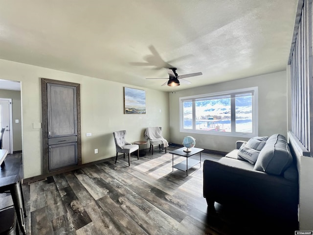 living room with ceiling fan, a textured ceiling, and hardwood / wood-style flooring