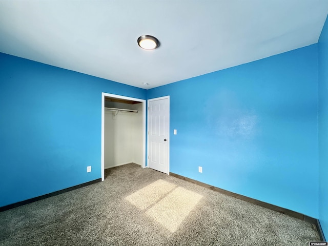 unfurnished bedroom with carpet and a closet