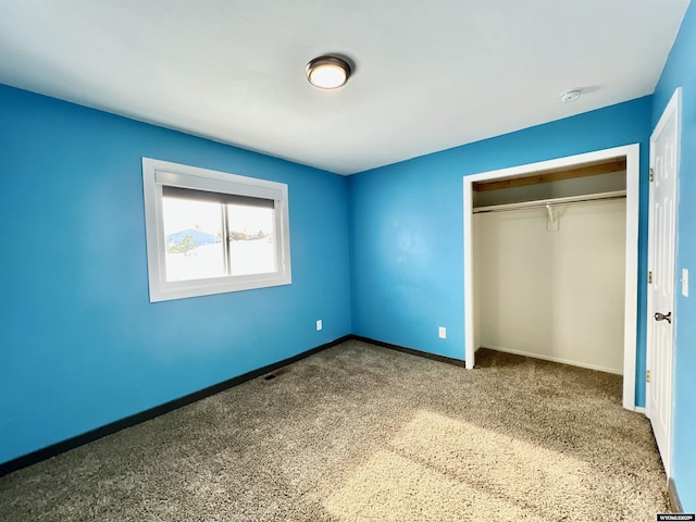 unfurnished bedroom with carpet and a closet