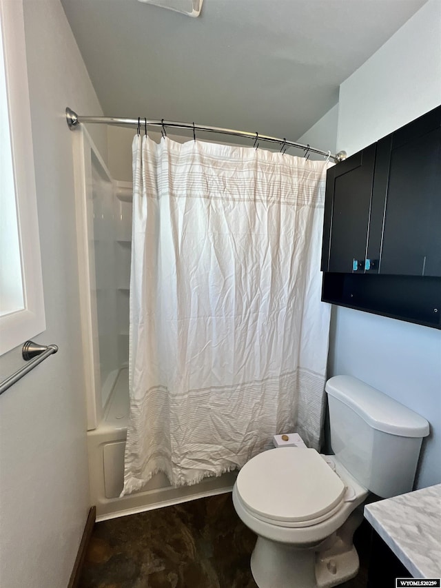 full bathroom with vanity, shower / tub combo, and toilet