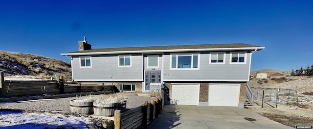 view of front facade featuring a mountain view and a garage