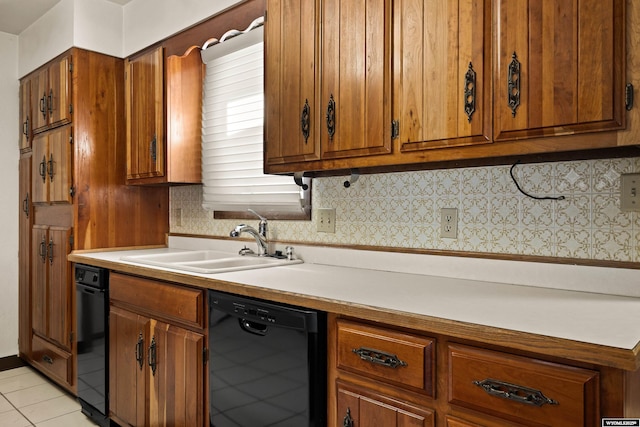 kitchen with sink, black dishwasher, and light tile patterned flooring