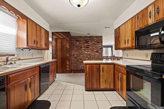 kitchen featuring sink, tasteful backsplash, light tile patterned floors, kitchen peninsula, and black appliances