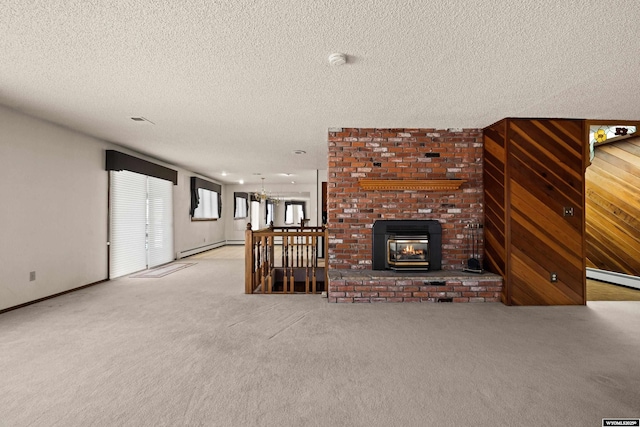 unfurnished living room featuring a baseboard heating unit, light carpet, a textured ceiling, and a fireplace