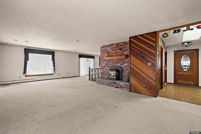 unfurnished living room featuring light carpet, wooden walls, a textured ceiling, and baseboard heating