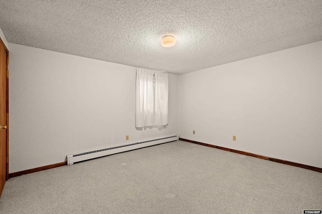 spare room with a baseboard radiator, carpet floors, and a textured ceiling