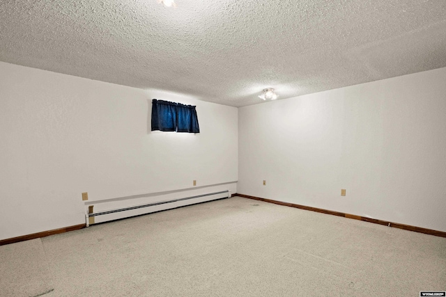 carpeted spare room with a textured ceiling and baseboard heating