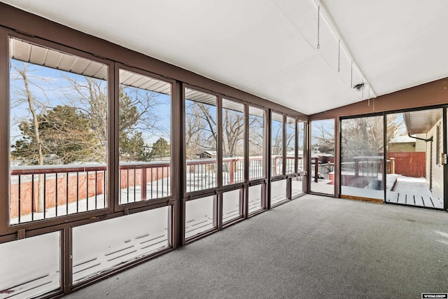 unfurnished sunroom featuring vaulted ceiling