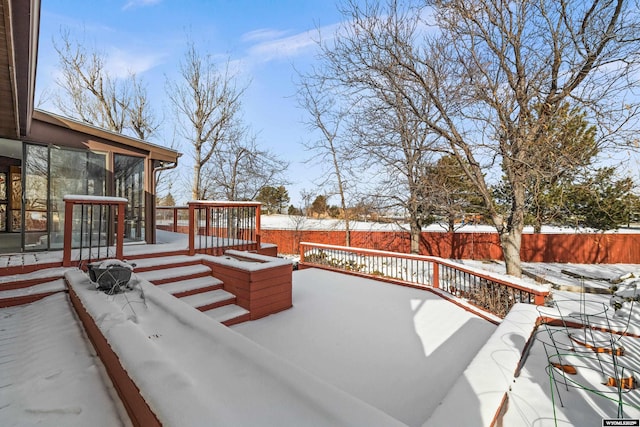 snow covered deck with a sunroom