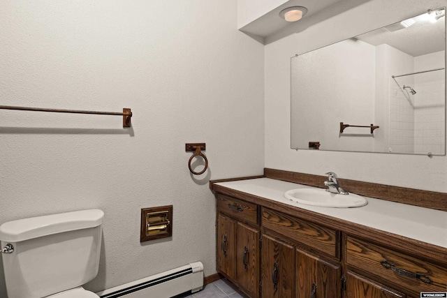 bathroom with vanity, a baseboard heating unit, tile patterned floors, and toilet