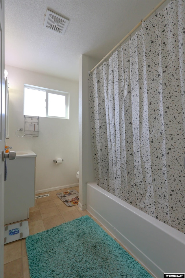 bathroom featuring toilet, vanity, and tile patterned floors