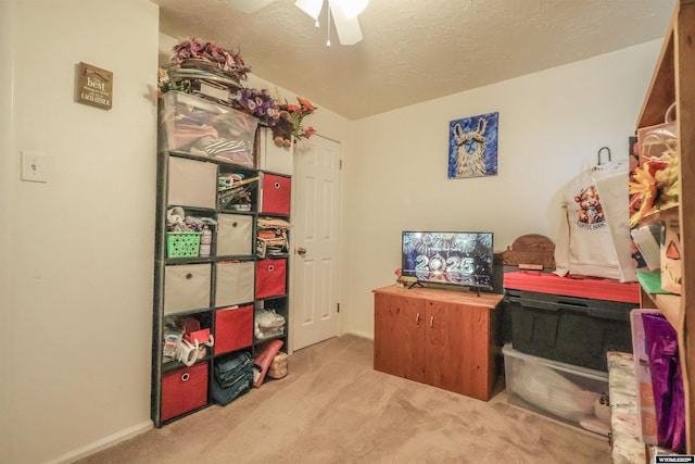 home office featuring light carpet and ceiling fan