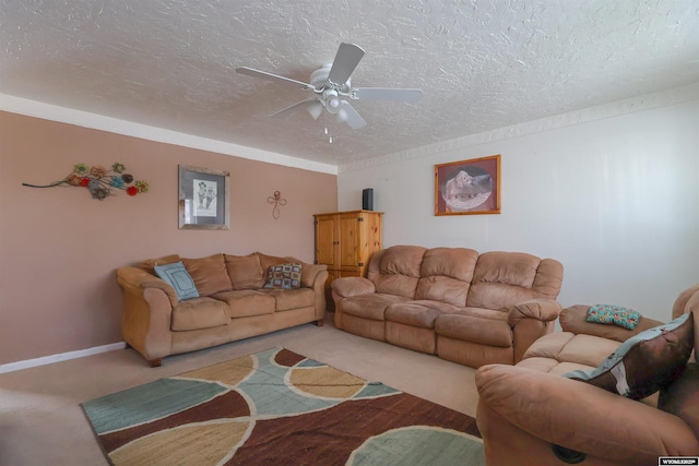 living room with ceiling fan, carpet, a textured ceiling, and ornamental molding