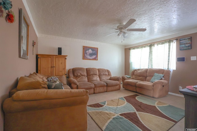 carpeted living room featuring ceiling fan and a textured ceiling