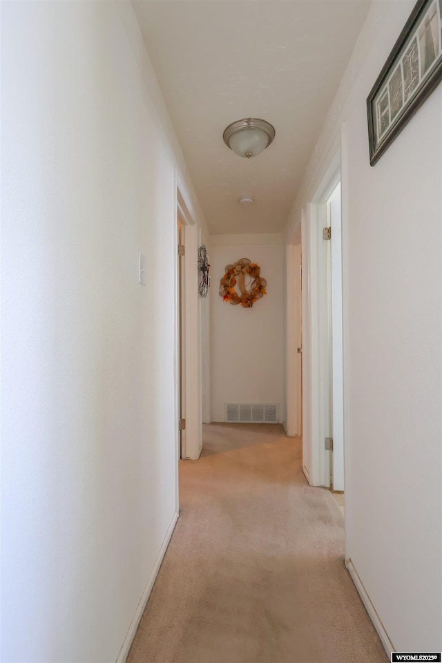 hallway with light colored carpet