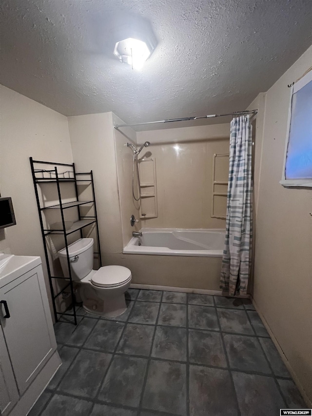 full bathroom featuring vanity, a textured ceiling, shower / bath combo with shower curtain, washer / clothes dryer, and toilet