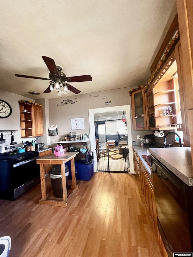 kitchen with sink, dishwasher, ceiling fan, and light wood-type flooring