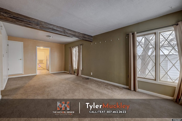 carpeted spare room featuring beamed ceiling and a textured ceiling