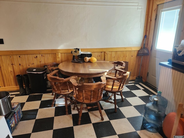 dining room with wood walls