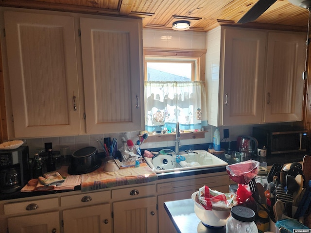 kitchen with sink, wood ceiling, and decorative backsplash