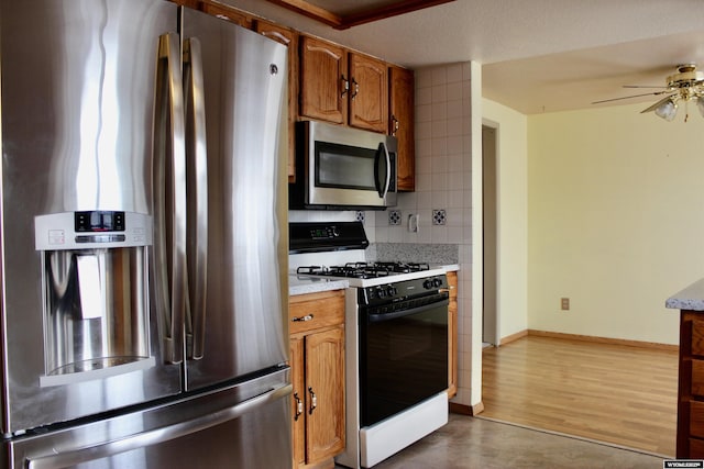 kitchen with decorative backsplash, ceiling fan, dark hardwood / wood-style floors, a textured ceiling, and stainless steel appliances