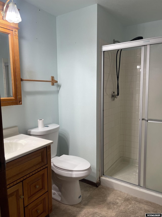 bathroom with vanity, toilet, and walk in shower