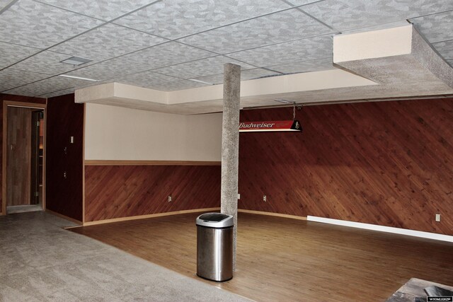 basement featuring wooden walls