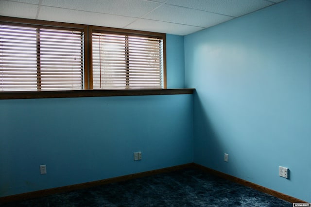 empty room with dark colored carpet