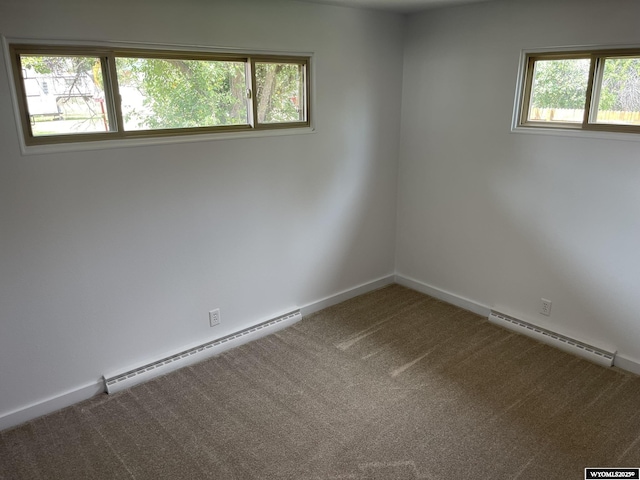 empty room with a wealth of natural light and a baseboard heating unit