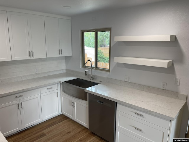 kitchen with sink, stainless steel dishwasher, dark hardwood / wood-style floors, light stone countertops, and white cabinetry