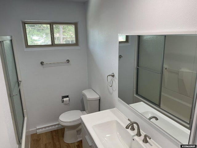 bathroom featuring hardwood / wood-style floors, vanity, toilet, and baseboard heating