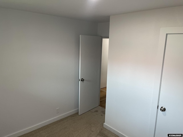 unfurnished bedroom with light carpet