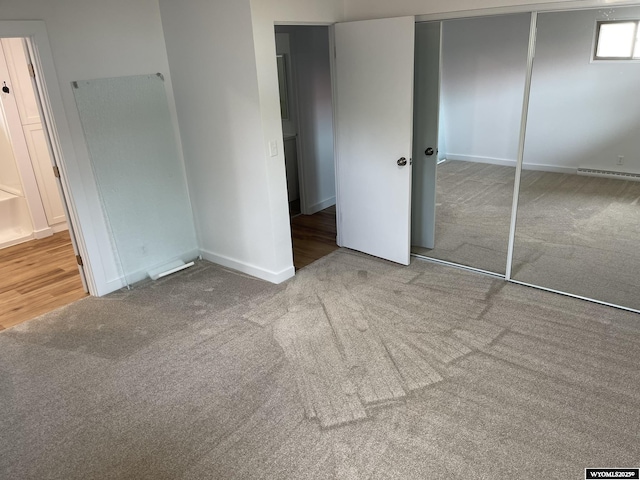 unfurnished bedroom with a closet and carpet floors