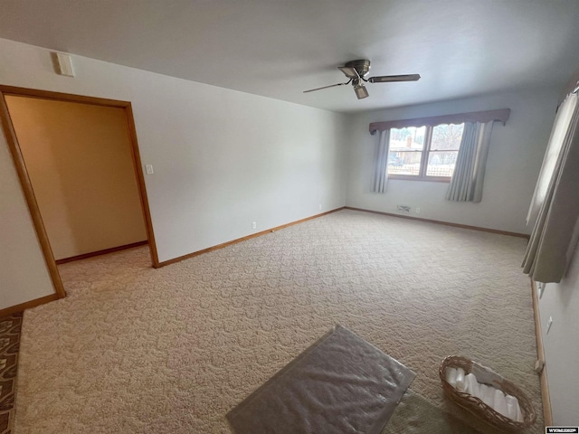 unfurnished room with ceiling fan and light carpet