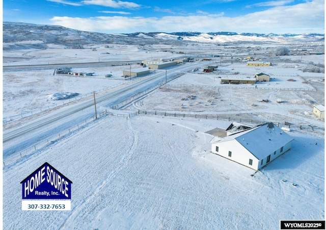 snowy aerial view featuring a mountain view