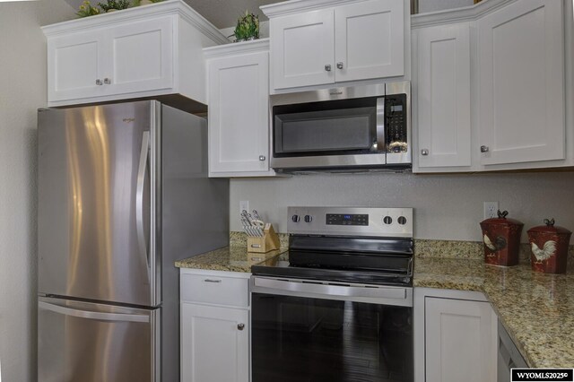 kitchen with white cabinets and appliances with stainless steel finishes