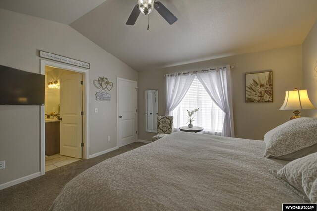 bedroom featuring ensuite bath, ceiling fan, light colored carpet, and lofted ceiling