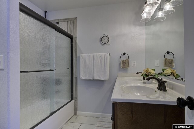 bathroom with shower / bath combination with glass door and vanity