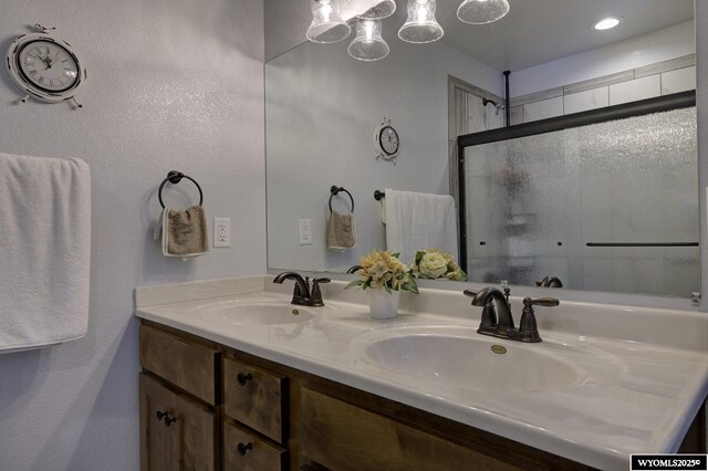 bathroom featuring vanity and an enclosed shower