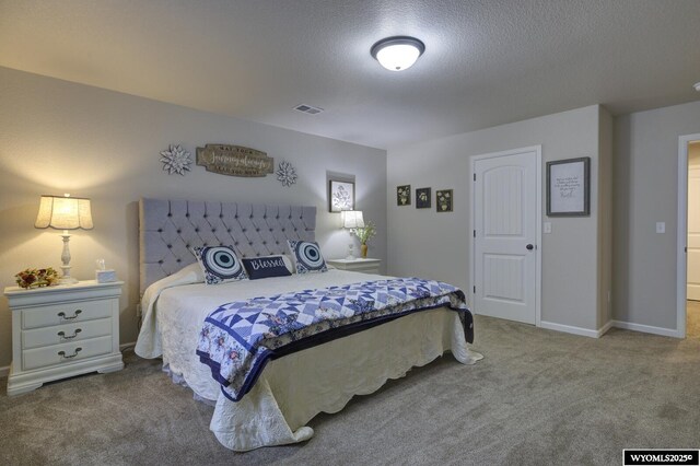 carpeted bedroom with a textured ceiling