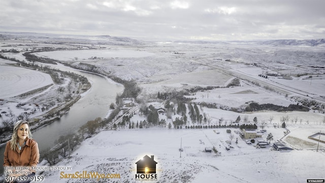 snowy aerial view with a mountain view